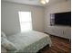 Relaxing bedroom with queen-size bed and large TV at 4201 Avanti Cir, New Port Richey, FL 34655