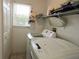 Bright laundry room with washer, dryer, and shelving at 4201 Avanti Cir, New Port Richey, FL 34655
