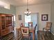 Dining area with wooden table and chairs, and access to the backyard at 4201 Avanti Cir, New Port Richey, FL 34655