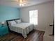 Cozy bedroom with queen-size bed and teal accents at 4201 Avanti Cir, New Port Richey, FL 34655