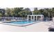 Community pool with plenty of lounge chairs at 4201 Avanti Cir, New Port Richey, FL 34655