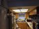 Small kitchen with wood cabinets and a cluttered countertop at 3310 68Th N Ave, St Petersburg, FL 33702