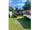 House exterior with a cluttered backyard and a pickup truck at 3310 68Th N Ave, St Petersburg, FL 33702