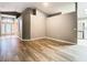 Light-filled living area with hardwood floors and views to entryway and kitchen at 7823 Floradora, New Port Richey, FL 34654