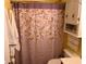 Clean bathroom with a floral shower curtain and wood vanity at 8388 Begonia St, Spring Hill, FL 34608