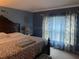 Spacious bedroom with a king-size bed and blue walls at 8388 Begonia St, Spring Hill, FL 34608