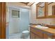 Bathroom with shower and wood vanity at 7208 Clouchester Ct, Hudson, FL 34667