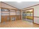 Gathering room features built-in shelving, fireplace, and access to patio at 7208 Clouchester Ct, Hudson, FL 34667