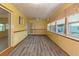Bright sunroom with wood-look flooring and multiple windows at 7208 Clouchester Ct, Hudson, FL 34667