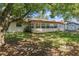 Back exterior view, showing a sunroom and shed at 7208 Clouchester Ct, Hudson, FL 34667