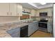 Kitchen with stainless steel appliances and light blue cabinets at 7208 Clouchester Ct, Hudson, FL 34667