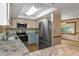 Modern kitchen boasts stainless steel appliances and a breakfast bar at 7208 Clouchester Ct, Hudson, FL 34667