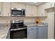 Stainless steel appliances and light blue cabinets in this kitchen at 7208 Clouchester Ct, Hudson, FL 34667
