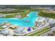 High aerial of the lagoon featuring an aqua park, sandy beach, bar, lounge, and water slide in a Gathering-friendly community at 31941 Blue Passing Loop, Wesley Chapel, FL 33545