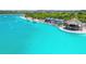 Aerial view showcases lagoon pool with cabanas and tiki bar, offering a relaxing and social atmosphere at 31941 Blue Passing Loop, Wesley Chapel, FL 33545