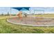Community playground featuring a shade cover, swings, and a slide for outdoor Gathering fun at 31941 Blue Passing Loop, Wesley Chapel, FL 33545
