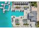 Aerial view showcasing a resort-style pool, cabanas, lounge chairs, and umbrellas by the crystal lagoon at 31941 Blue Passing Loop, Wesley Chapel, FL 33545