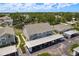 Aerial view of the property showcasing buildings, parking, and lush green surroundings at 7712 Hillside Ct # 202, Hudson, FL 34667