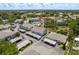 Wide aerial view showcasing the condo community, pool, landscaping, and surrounding neighborhood at 7712 Hillside Ct # 202, Hudson, FL 34667