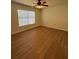 Bedroom showcasing a ceiling fan, window with blinds, and wood-look flooring at 7712 Hillside Ct # 202, Hudson, FL 34667