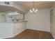 Dining room with chandelier and view of adjacent kitchen at 7712 Hillside Ct # 202, Hudson, FL 34667