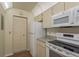 Eat-in kitchen features updated appliances and ample cabinet space at 7712 Hillside Ct # 202, Hudson, FL 34667