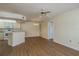 Open concept living space with wood-look flooring, ceiling fan and a dining area with kitchen view at 7712 Hillside Ct # 202, Hudson, FL 34667