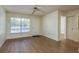 Living room with wood-look floors, closet, and a sunlit window at 7712 Hillside Ct # 202, Hudson, FL 34667