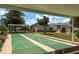 Relaxing shuffleboard courts with shaded seating and a clubhouse creating a relaxing community at 7712 Hillside Ct # 202, Hudson, FL 34667