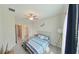 Cozy bedroom with striped bedding and ceiling fan at 31941 Blue Passing Loop, Wesley Chapel, FL 33545