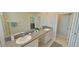 Double vanity bathroom with granite countertop at 31941 Blue Passing Loop, Wesley Chapel, FL 33545