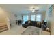 Open living area showcasing a sectional sofa, dining set, and staircase at 31941 Blue Passing Loop, Wesley Chapel, FL 33545