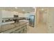 Modern kitchen with island, granite countertops, and stainless steel appliances at 31941 Blue Passing Loop, Wesley Chapel, FL 33545