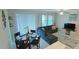 Bright dining area with glass-top table and seating for four, near living room at 31941 Blue Passing Loop, Wesley Chapel, FL 33545