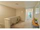 Upstairs hallway with seating area and views to bedrooms at 31941 Blue Passing Loop, Wesley Chapel, FL 33545