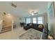 Spacious living room featuring L-shaped sectional sofa and adjacent dining area at 31941 Blue Passing Loop, Wesley Chapel, FL 33545