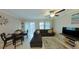 Comfortable living room with L-shaped sectional sofa and adjacent dining area at 31941 Blue Passing Loop, Wesley Chapel, FL 33545