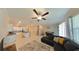 Open living room with sectional sofa and view of kitchen at 31941 Blue Passing Loop, Wesley Chapel, FL 33545