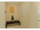Bright entryway with bench, plant, and coastal-themed art at 31941 Blue Passing Loop, Wesley Chapel, FL 33545