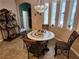 Charming breakfast nook features a mosaic-tiled table and wrought iron chairs at 11033 Baywind Ct, Weeki Wachee, FL 34613