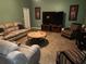Relaxing living room with neutral-toned furniture and a large flat-screen TV at 11033 Baywind Ct, Weeki Wachee, FL 34613