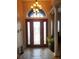 Bright entryway with hardwood floors and decorative chandelier at 11033 Baywind Ct, Weeki Wachee, FL 34613