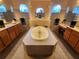 Luxurious bathroom with soaking tub and double vanities at 11033 Baywind Ct, Weeki Wachee, FL 34613