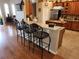 Kitchen counter with three bar stools, offering extra seating and workspace at 11033 Baywind Ct, Weeki Wachee, FL 34613