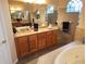 Elegant bathroom featuring double sinks and a large mirror at 11033 Baywind Ct, Weeki Wachee, FL 34613