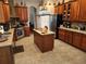 Spacious kitchen featuring wood cabinets, granite counters, and stainless steel appliances at 11033 Baywind Ct, Weeki Wachee, FL 34613