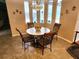 Cozy breakfast nook with a round table and chairs, overlooking the pool at 11033 Baywind Ct, Weeki Wachee, FL 34613