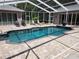 Refreshing pool with screened enclosure and ample patio space at 11033 Baywind Ct, Weeki Wachee, FL 34613