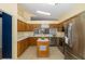 Kitchen boasts wood cabinets, stainless steel appliances & island at 1633 Arbor Knoll Loop, Trinity, FL 34655