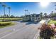 Gated community entrance with landscaping and guard house at 1633 Arbor Knoll Loop, Trinity, FL 34655